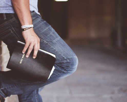 Acts 247 UK Worship Night Banner Image with wall pose holding bible for Q2 2026 events